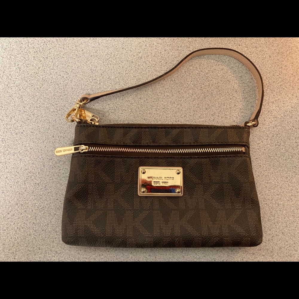 A Micheal Kors wristlet with card slots inside.